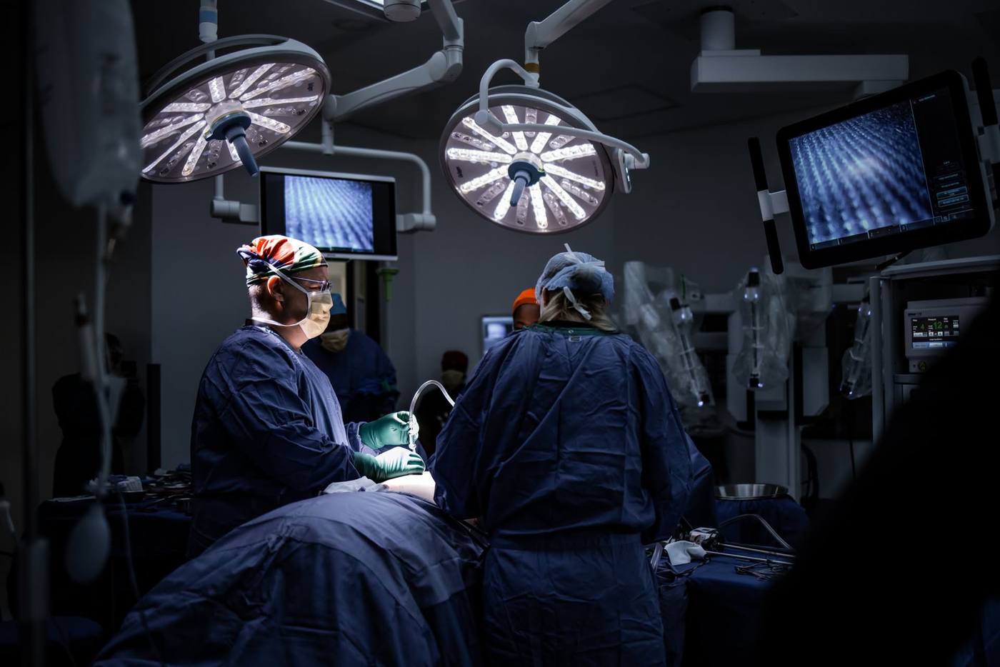 Dr Corné van Graan operating in theatre at Johannesburg Surgical Hospital, with the da Vinci robotic system in the background